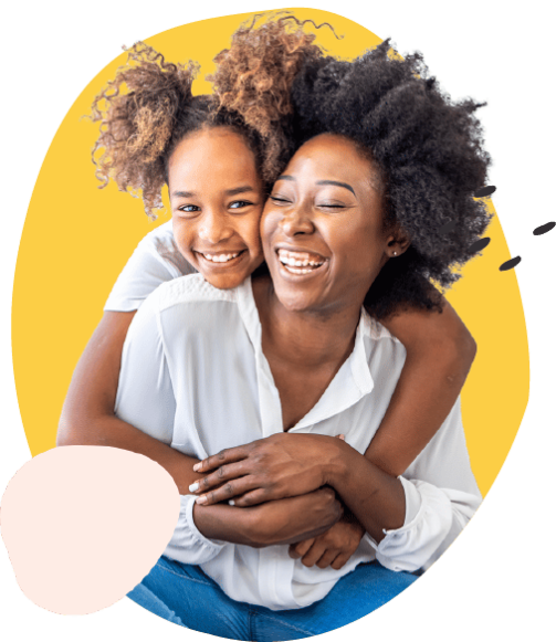 a smiling young girl hugging her foster parent who is fostering in devon