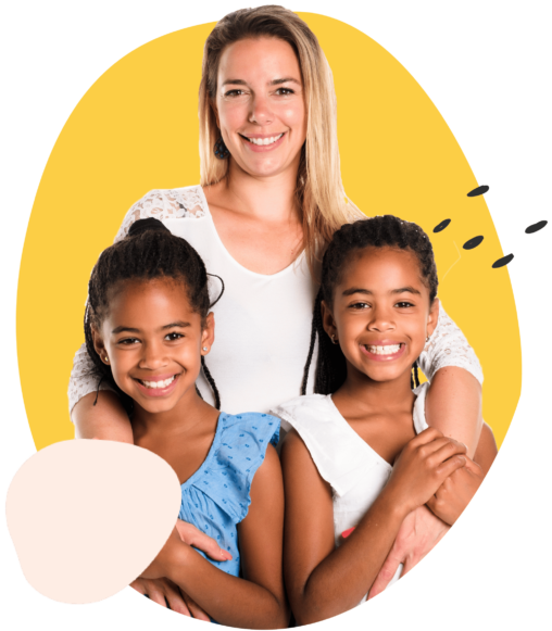 woman hugging two young children