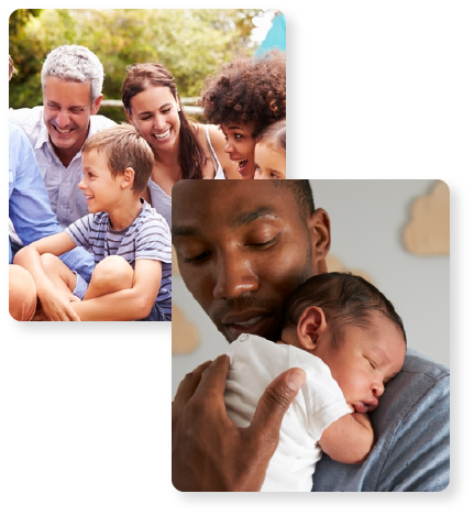 man hugging a baby and a group of adults and children sitting in a park