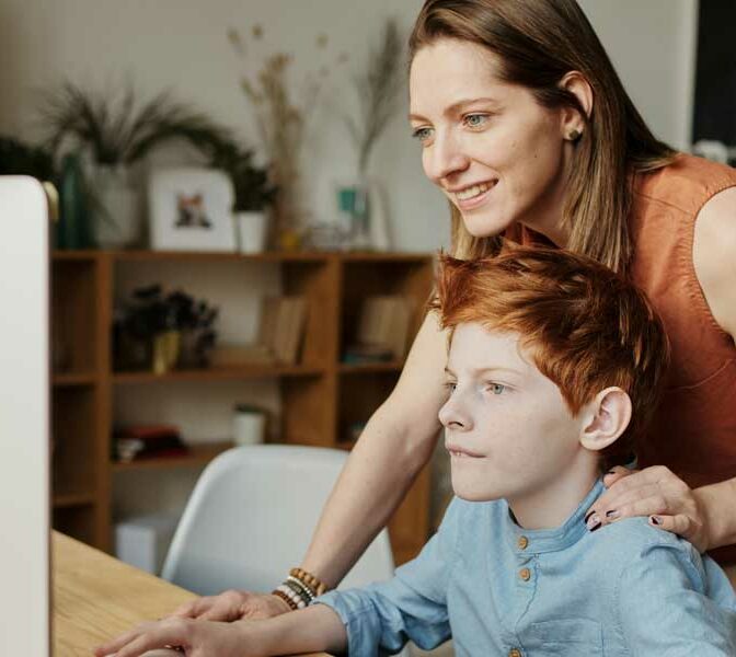 Freya has followed in her mum's footsteps and is a foster carer like her mum. Picture shows Freya helping a boy with his computer studies
