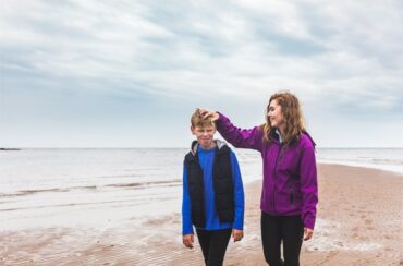 girl and boy walking on the beach