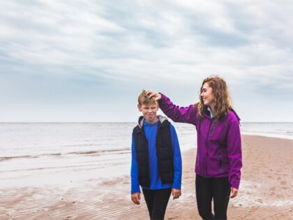 girl and boy walking on the beach