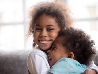 young girl hugging young boy