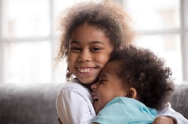 young girl hugging young boy