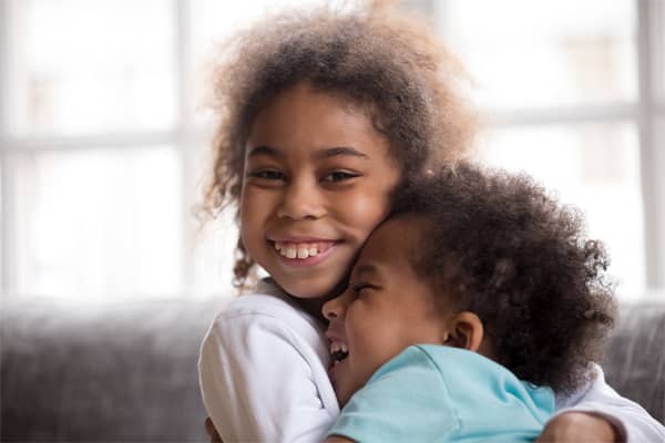 young girl hugging young boy