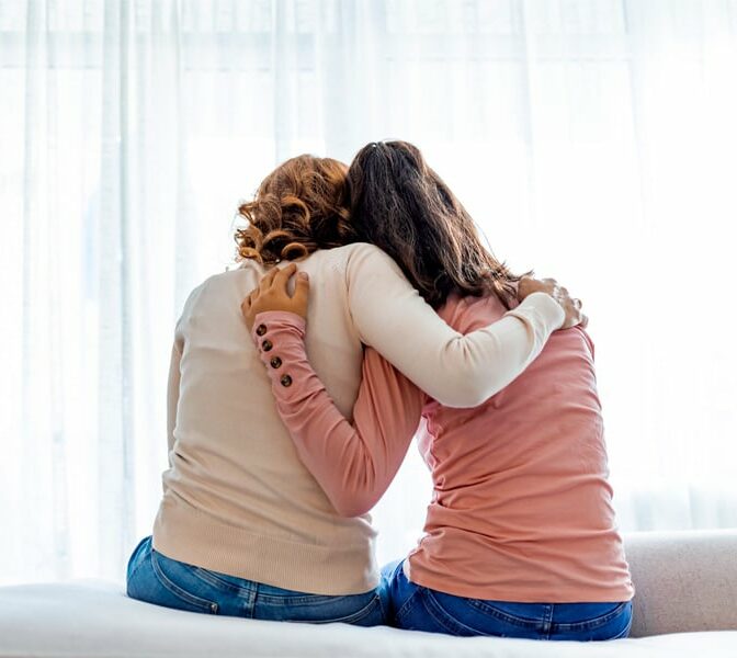 young girl and adult woman hugging