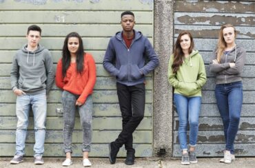 teenagers stood against a wall