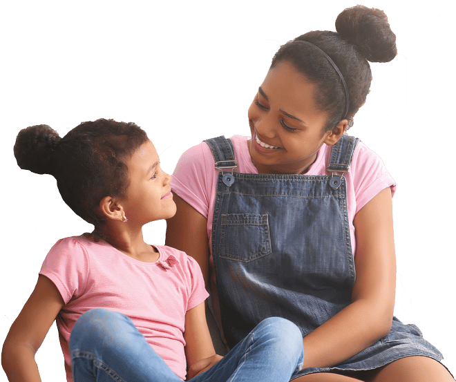 Two young girls sitting and smiling