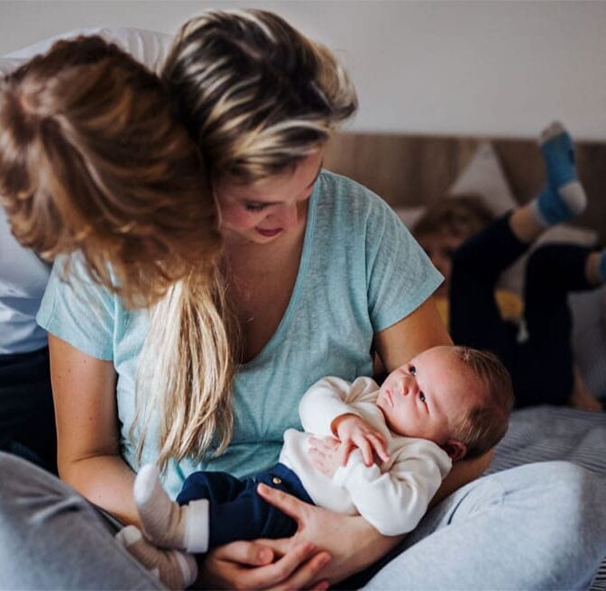 Young couple looking at a baby