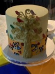 White cake with golden icing shaped into a tree