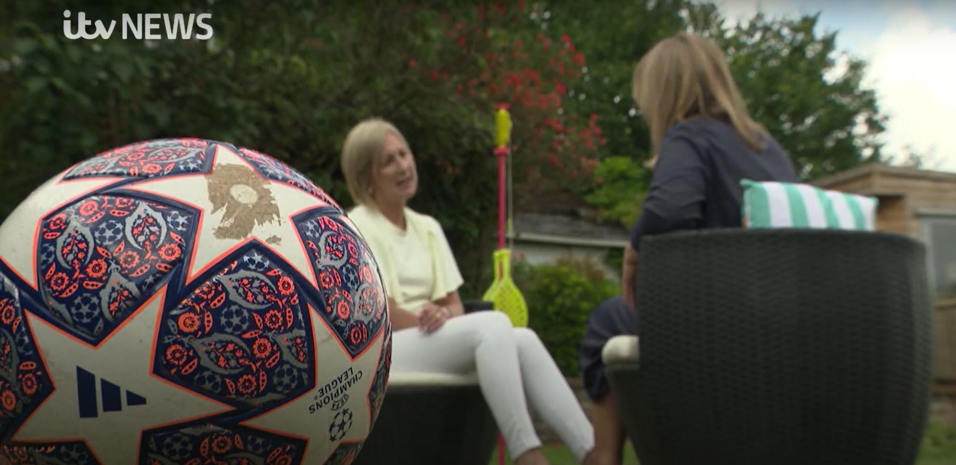 Mockingbird in Devon feature on ITV news. picture shows home hub carer talking to reporter in the garden