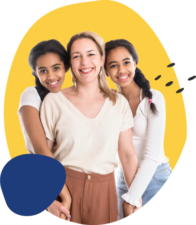 A smiling woman stands in the center while two smiling girls lean in and hug her from both sides, all wearing light-colored tops against a bright yellow background.