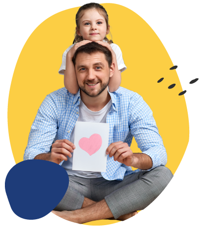 A smiling father sits cross-legged holding a card with a pink heart, while his young daughter rests on his shoulders with her hands on his head, both facing the camera against a bright yellow background.