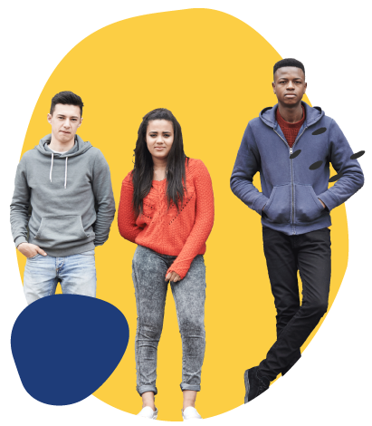 Three young adults stand side by side against a yellow abstract background with a transparent checkerboard around it. From left to right: a person in a gray hoodie and light jeans with hands in pockets, a person in a red sweater and patterned gray pants standing with feet together, and a person in a blue zip-up hoodie and black pants standing casually with one leg crossed. A dark blue abstract shape appears near the lower left.